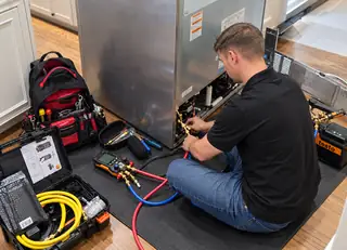 Pulse technician performing sealed-system refrigerator service in Appling, GA